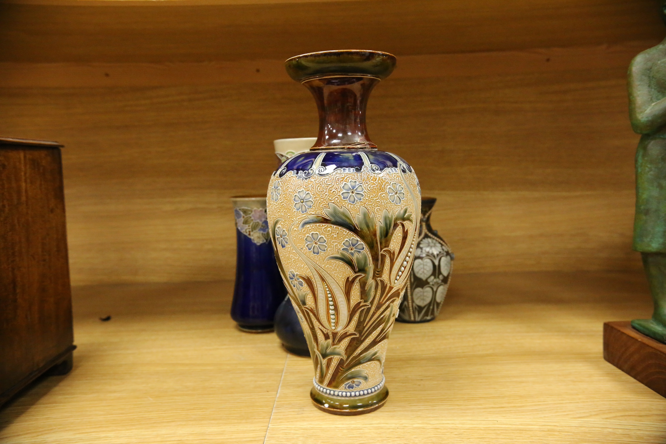 Four Royal Doulton vases and a yellow glazed jug items, tallest vase 34cm high. Condition - some crazing and faults, large vase has damage to lower neck